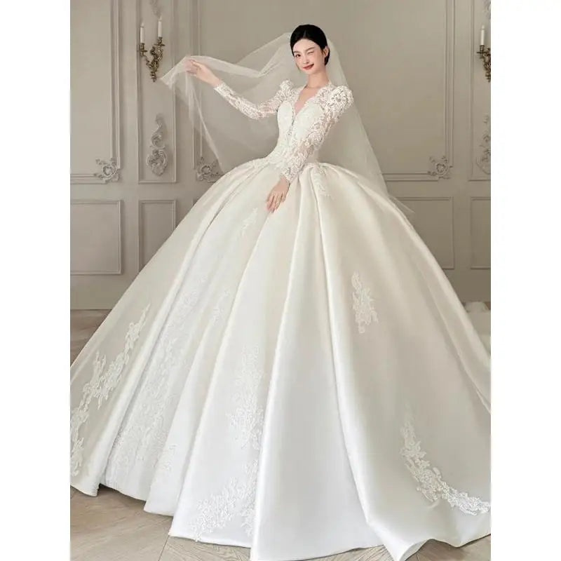 Robe de mariée satinée à col V et manches longues – CLEVI Paris
